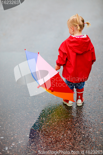 Image of Toddler girl outdoors at rainy day