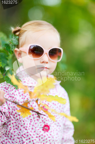 Image of Cute girl in autumn park