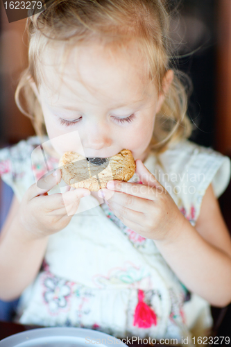 Image of Girl eating cookie