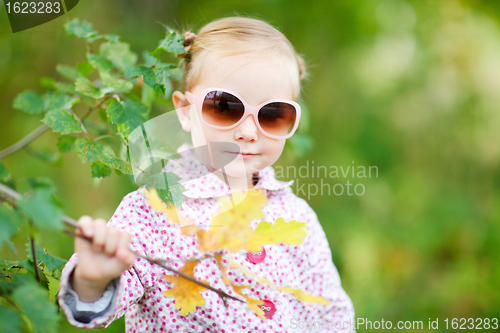 Image of Cute girl in autumn park