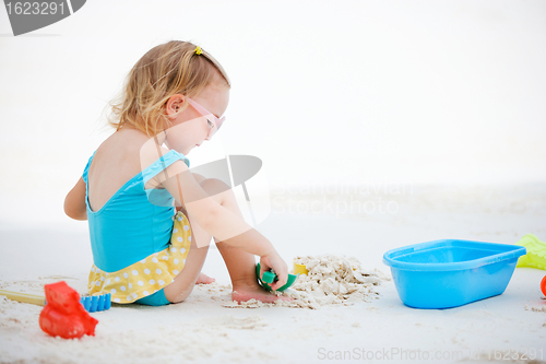 Image of Little girl playing at beach