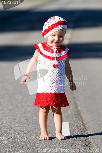 Image of Playful toddler girl on road