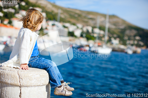 Image of Little girl enjoying sea view