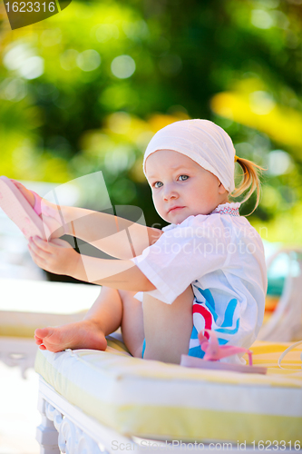Image of Girl relaxing near swimming pool