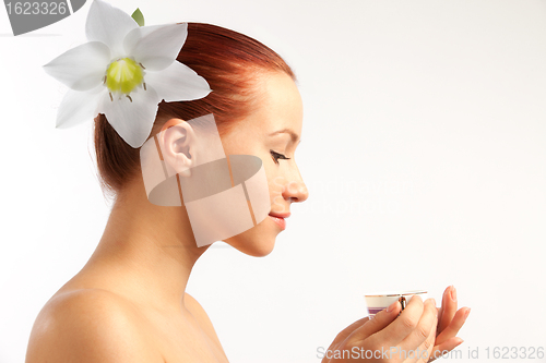 Image of naked girl with flower in hairs