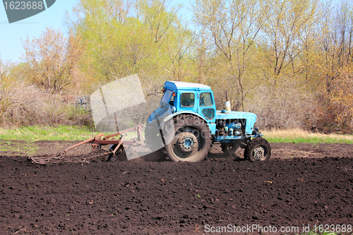 Image of old tractor with plough