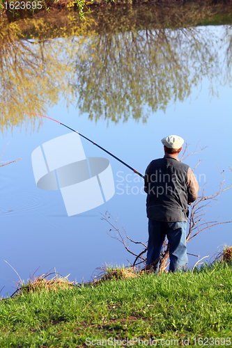 Image of fishing senior on lake