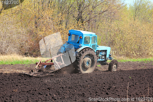 Image of old tractor with plough