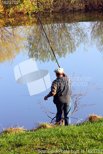 Image of fishing senior on lake