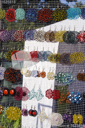 Image of Many colorful handmade earrings sale market fair 