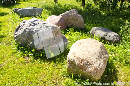 Image of Large stones garden verdant meadow rural scenery 