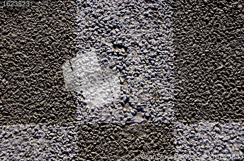 Image of Background macro closeup of  asphalt road marks 