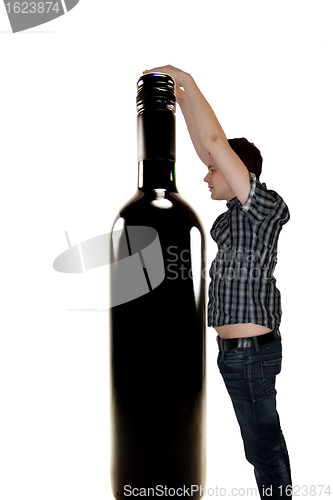 Image of Man reaching for wine bottle