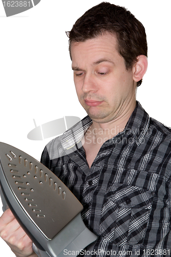 Image of Man looking on a iron and wondering