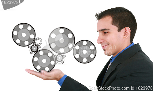 Image of Businessman holding some mechanisms in his hands 
