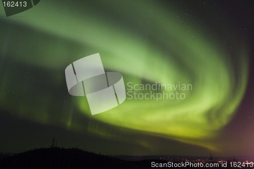 Image of Aurora swirls over town