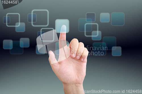 Image of hand pushing a button on a touch screen interface 