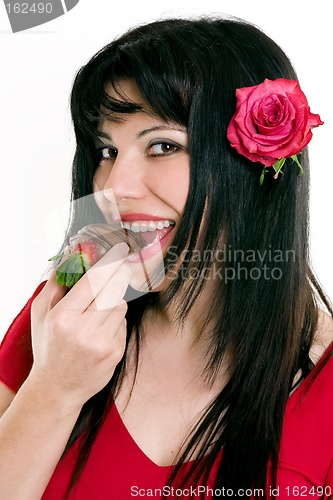 Image of Female eating fresh strawberries in chocolate