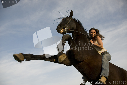 Image of happy girl and rearing stallion