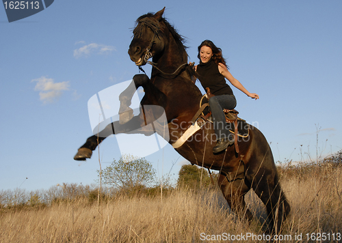 Image of rearing stallion and girl