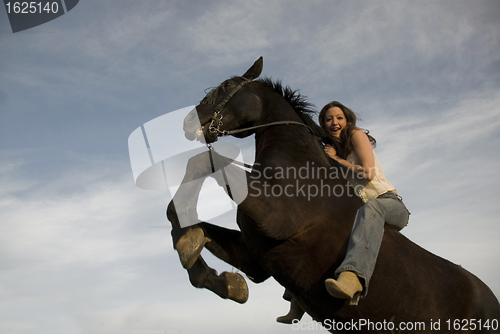 Image of happy girl and rearing stallion