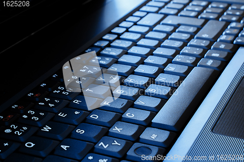 Image of laptop keyboard as a background tonet to blue