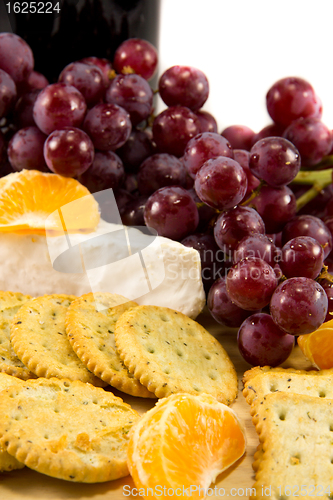Image of Crackers with grapes, brie, and some clementins