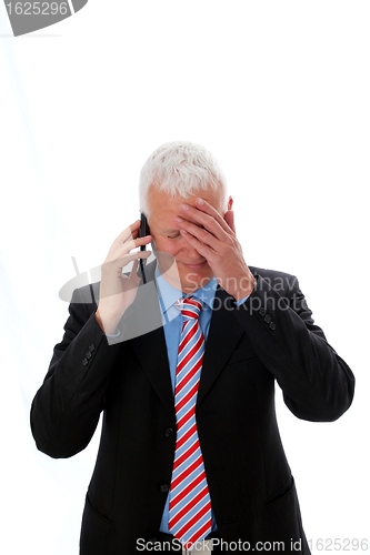 Image of Businessman disappointed calling with hand on forehead