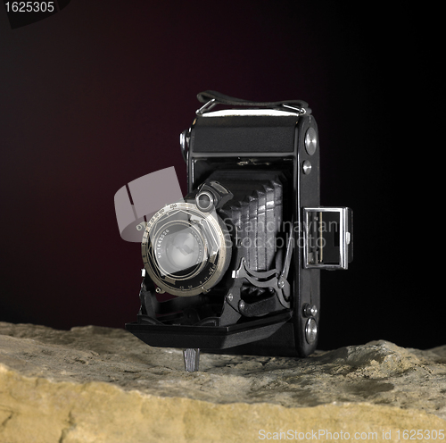 Image of nostalgic camera on stone surface