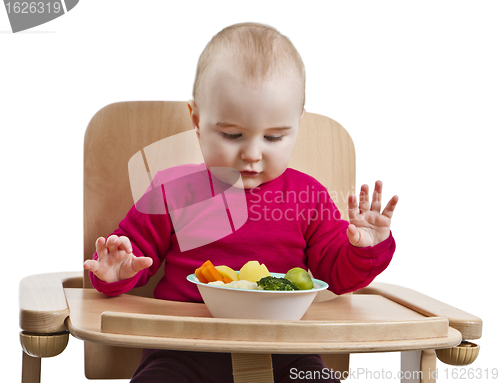 Image of young child eating in high chair