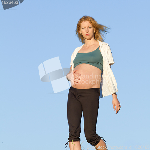 Image of pregnant woman on meadow