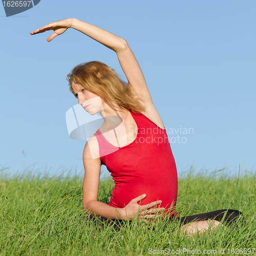 Image of pregnant woman on meadow