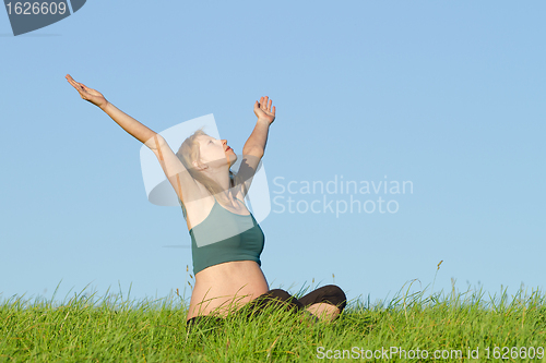 Image of pregnant woman on meadow