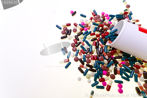 Image of pills spilling out of container 
