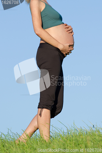 Image of pregnant woman on meadow