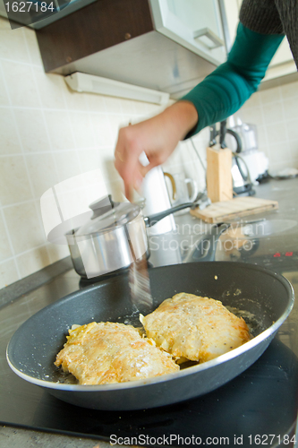 Image of chef frying salmon steak