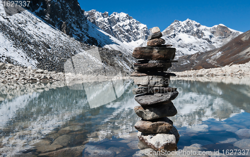 Image of stability: Stone stack and Sacred Lake near Gokyo 