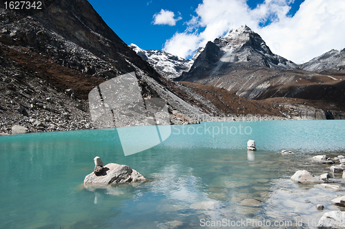 Image of Pebble stacks and Sacred Lake near Gokyo