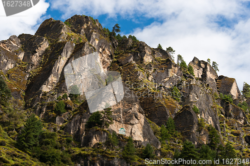 Image of Himalaya Landscape: rocks, trees and Buddhist symbols