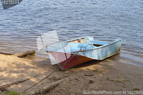 Image of Metal boat on the riverbank