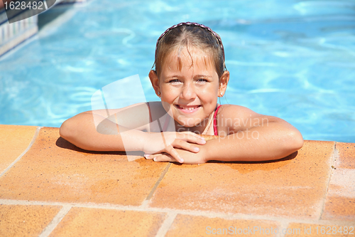 Image of Happy girl smiling at swimming pool