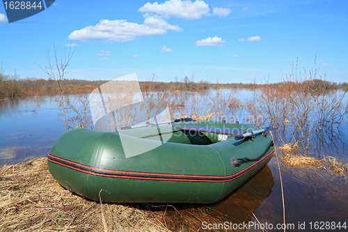 Image of rubber boat on coast river