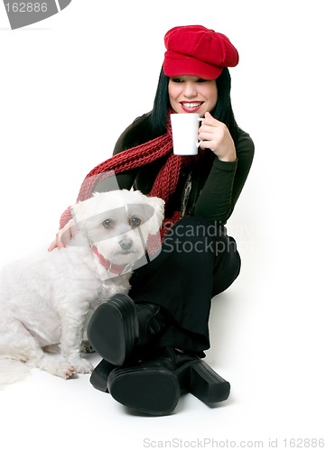 Image of Woman relaxing with a small pet dog