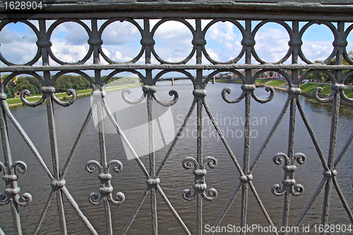 Image of bridge banisters through greater river