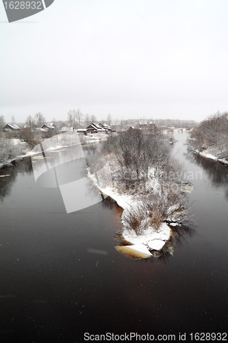 Image of snow village on coast river 