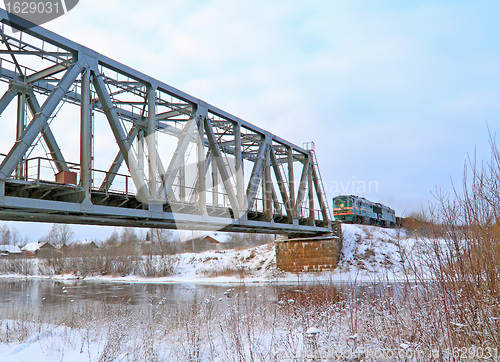 Image of train on bridge through river 