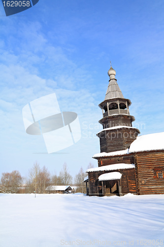 Image of wooden chapel on snow field 