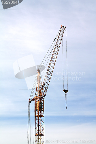 Image of building crane on cloudy background