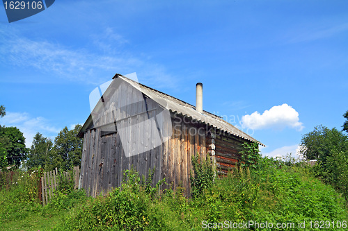 Image of wooden rural house amongst herbs