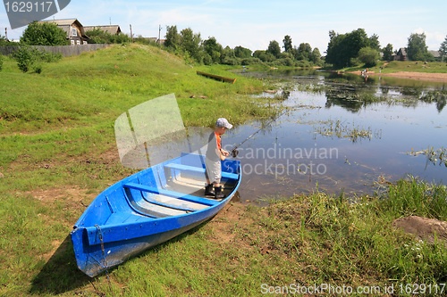 Image of boy fishes on coast river